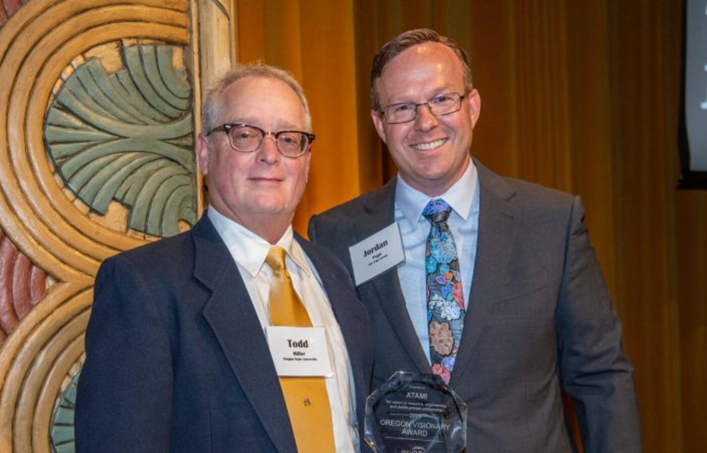 Todd Miller, Director of ATAMI, posing with the Oregon Visionary Award.